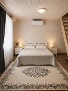 a bedroom with a large bed with two night stands at Вілла Смерекова хата in Kelechin