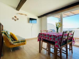 a dining room with a table and chairs and a window at Loft Al Baglio del Gelso in Balestrate