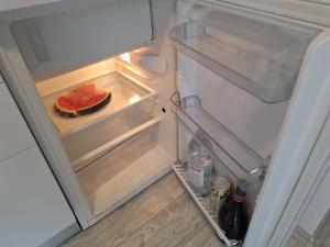 an open refrigerator with a slice of watermelon in it at Fiore apartment & room in Krk