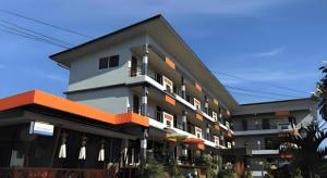 a large building with an orange and gray at Nan Treasure Hotel in Ban Hua Wiang Nua