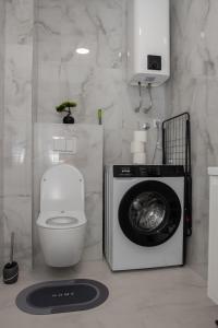 a bathroom with a washing machine and a toilet at Apartman Solis in Trebinje +37 photos