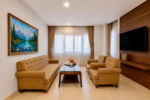 a living room with two couches and a tv at T78 Luxury Hotel in Ho Chi Minh City