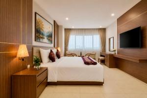 a hotel room with a bed and a desk at T78 Luxury Hotel in Ho Chi Minh City +41 photos