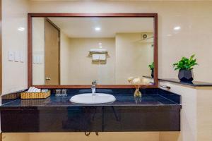 a bathroom with a sink and a large mirror at T78 Luxury Hotel in Ho Chi Minh City