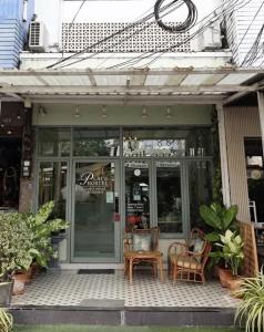 a store front with chairs and tables on a patio at Mukdahan Residence Hotel in Mukdahan