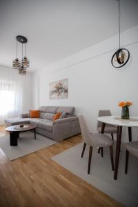 a living room with a couch and a table at Apartman Solis in Trebinje