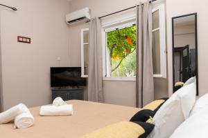 a living room with a table and a window at Mani Spot Casa Elia in Areopoli