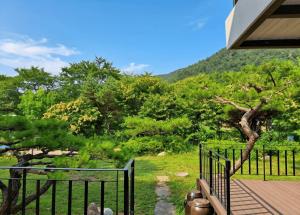 a balcony of a house with a view of a mountain at Gapyeong Yunseul Pension in Chuktul-li
