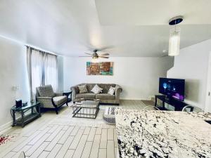 a living room with a couch and a tv at Hopes Cozy Condo in Phoenix