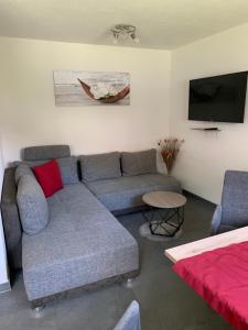 a living room with a couch and a flat screen tv at Apart Wackernell in Nauders
