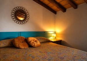 a bedroom with a bed with two pillows on it at La Locanda Del Tevere Slow tourism near Rome in Fiano Romano