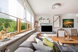 a living room with a couch and a tv at Ferienwohnung Laura in Illertissen
