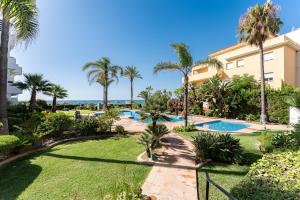 a resort with a swimming pool and palm trees at 203 Arruzafa Sea View in Málaga