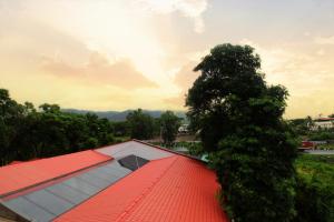 a tree sitting on top of a red roof at Hotel Sai Residency in Karjat