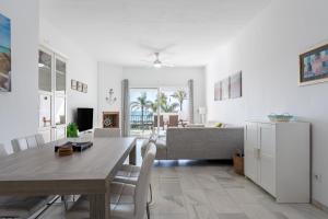 a living room with a table and a couch at 203 Arruzafa Sea View in Málaga
