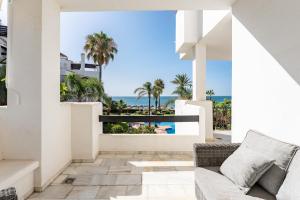 a living room with a couch and a view of the ocean at 203 Arruzafa Sea View in Málaga