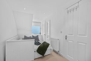 a white room with a bed and a window at Conners in Gardenstown