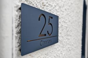 a blue clock on the side of a wall at Conners in Gardenstown