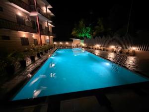 an empty swimming pool at night with lights at The Rosetta Inn, Wayanad in Wayanad
