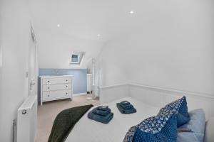 a bedroom with a bed with blue pillows on it at Conners in Gardenstown