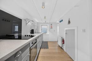a kitchen with white counters and a white ceiling at Conners in Gardenstown +44 photos
