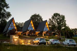 three cars parked in front of a building at Homeland Nest in Žabljak