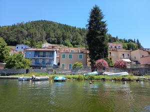 a group of boats in the water in front of houses at Setteacque Lakeview Rooms in Piediluco