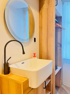 a bathroom with a white sink and a mirror at Guest house雅 in Matsudo +9 photos