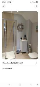 a bathroom with a shower stall and a toilet at Spacious Luxury Room in Brixham