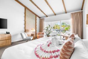a bedroom with a large white bed with a large window at Van der Valk Plaza Resort Bonaire - All Inclusive in Kralendijk
