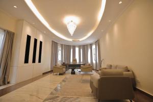 a living room with a couch and a piano at Jimma Palace Hotel in Jīma +52 photos