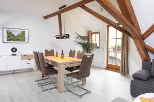 a dining room with a wooden table and chairs at Winzerhof Nagel in Dettelbach