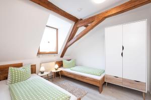 a bedroom with two beds and a window at Winzerhof Nagel in Dettelbach