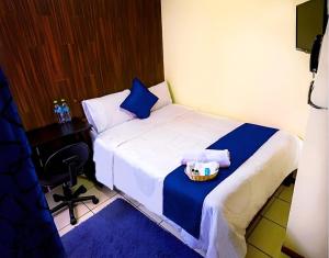 a hotel room with a bed with a tray of food on it at Hotel Inkas in Arequipa