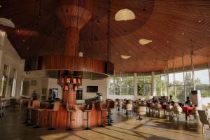 a large room with tables and chairs and windows at Jimma Palace Hotel in Jīma