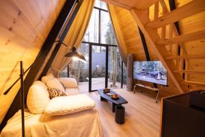 a living room with a large window and a tv at YEYU Hotel in Dujiangyan