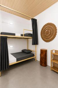 a room with two bunk beds in a room at Fins Arugambay in Arugam Bay