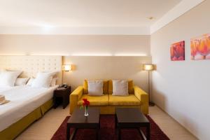 a hotel room with a bed and a couch at Barcelo Royal Beach - All Inclusive in Sunny Beach