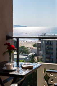 a balcony with a table with a view of the beach at Barcelo Royal Beach - All Inclusive in Sunny Beach