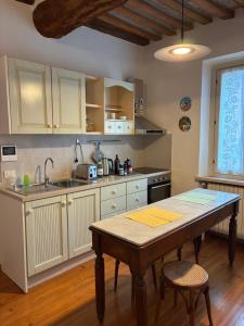 a kitchen with a wooden table and a sink at Casa la Mirage 6 in Bozzolo
