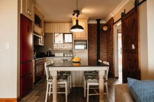 a kitchen with a table with a bowl of fruit on it at 2 Zebra View, Cathkin Estate in Winterton