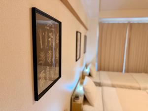 a picture hanging on a wall in a room at ura 東横のヨコ405 in Okayama