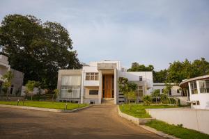 a large white building with a driveway at Jimma Palace Hotel in Jīma