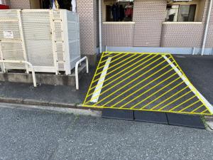 a yellow barricade on the side of a street at アルゴ境川 in Kitakyushu +1 photo