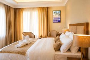 a hotel room with a large white bed with pillows at Hotel Dekiling by Eastlynn Collections in Leh