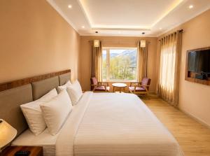 a hotel room with a large bed and a window at Hotel Dekiling by Eastlynn Collections in Leh