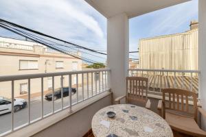 a balcony with a table and a view of a street at MM Delta Holidays in El Lligallo del Gànguil