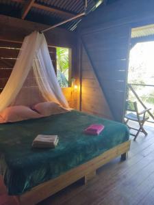 a bedroom with a bed with a mosquito net at Bambou cabane intimiste in Saint-Louis +24 photos
