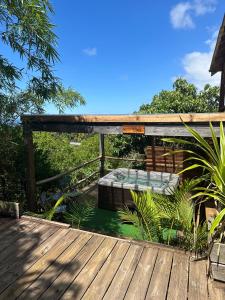 a wooden deck with a bed on top of it at Bambou cabane intimiste in Saint-Louis