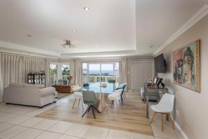 a living room with a table and chairs at Seaview Manor Exquisite Bed & Breakfast in Durban
